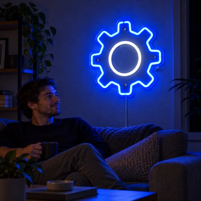 Gear Wheel Neon LED Sign on a living room wall, a person relaxing on the sofa in front of it