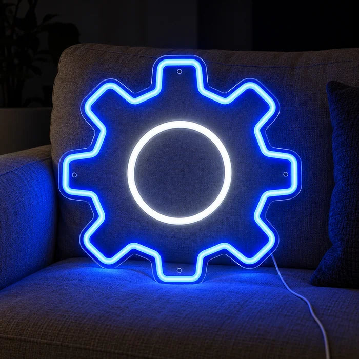 Gear Wheel Neon LED Sign on a cosy sofa between cushions and a throw