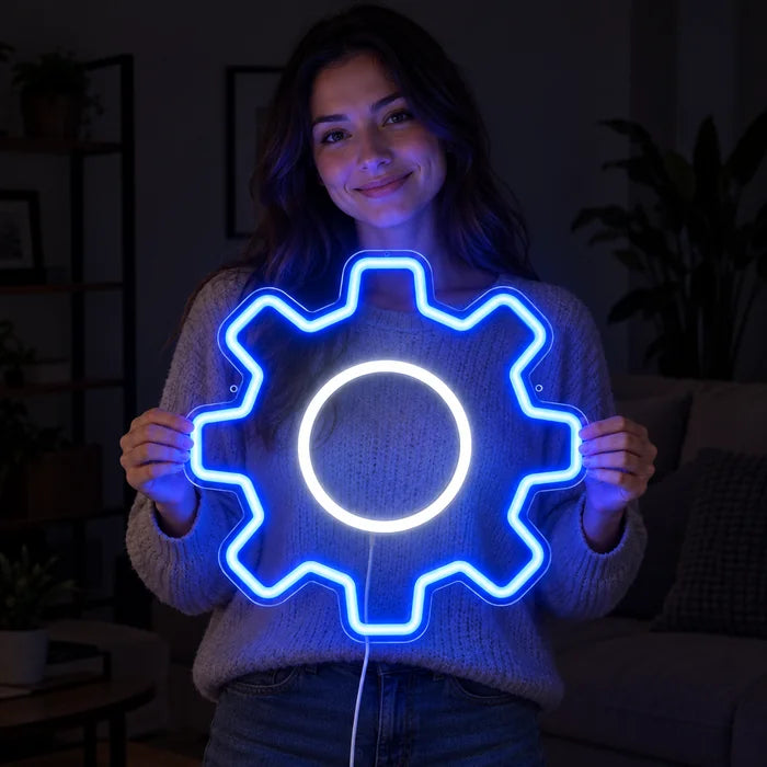Gear Wheel Neon LED Sign held by a smiling woman against a dark background
