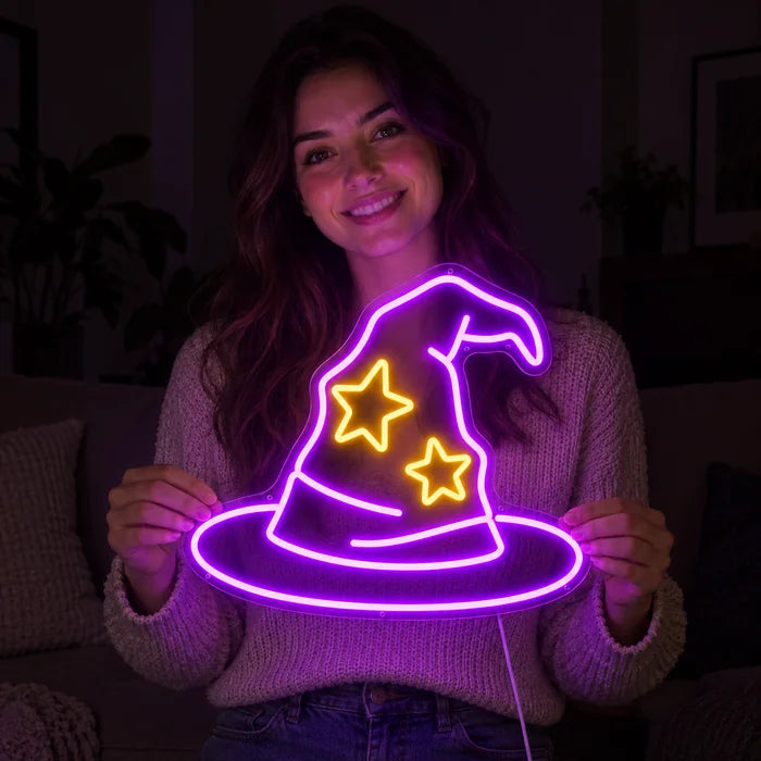Wizard Hat Neon LED Sign held by a smiling woman against a dark background