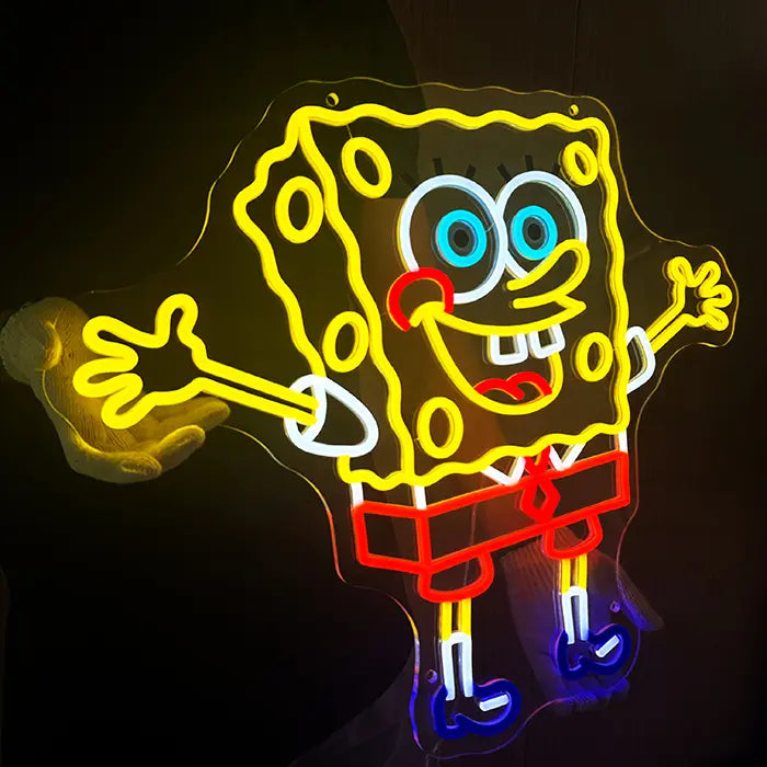 Schwammfigur Neon LED Schild leicht gedreht fotografiert, die gelben Arme und die rote Hose leuchten kräftig