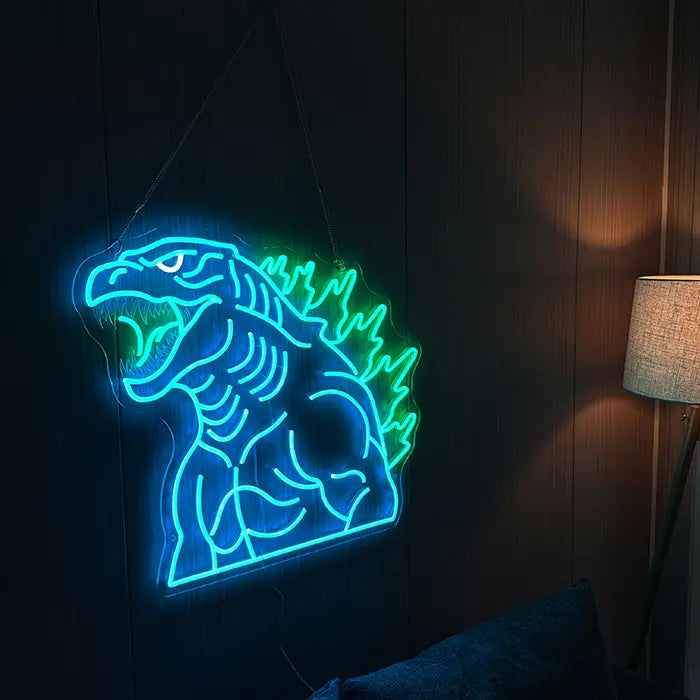 Godzilla Neon LED Sign, Power of the Green Flame motif: on a dark wall beside a floor lamp