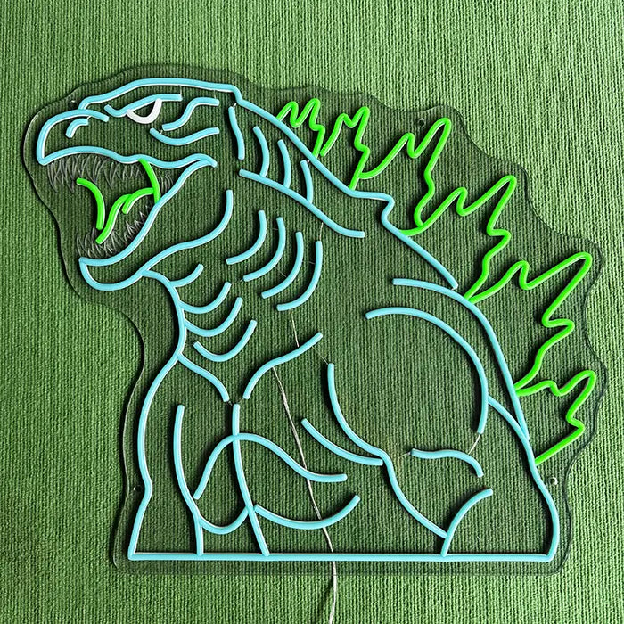 Godzilla Neon LED Sign switched off on a green surface, the complete contour visible