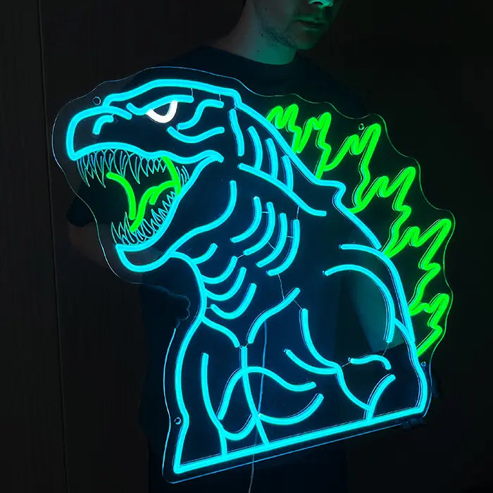 Godzilla Neon LED Sign head-on against a dark wall, the open mouth with a row of teeth clearly visible