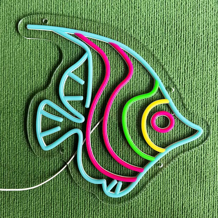 Ocean Fish Neon LED Sign switched off on a green surface, the complete contour clearly visible