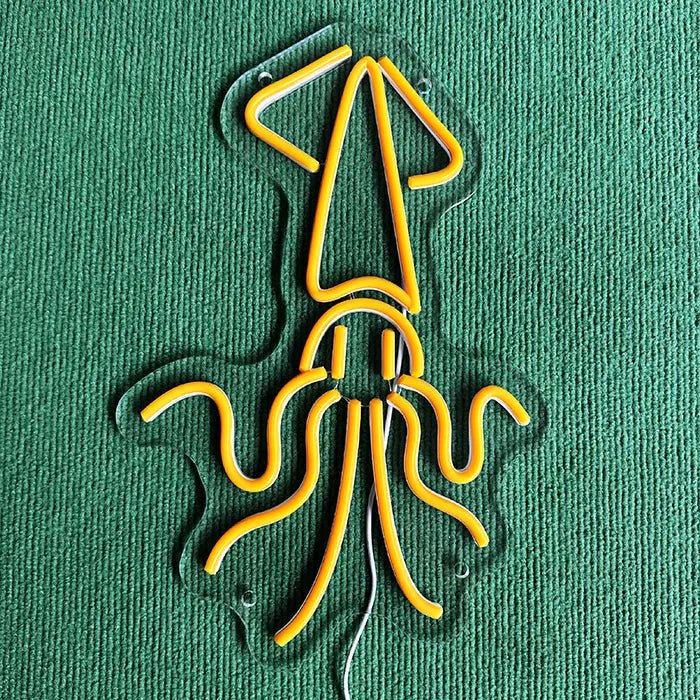Gold Octopus Neon LED Sign switched off on a green surface, the contour clearly visible