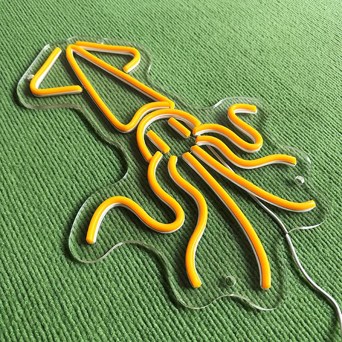 Gold Octopus Neon LED Sign switched off at an angle from above, neon tubing standing out on the acrylic