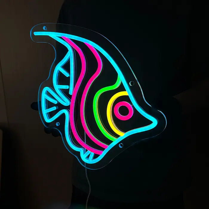 Ocean Fish Neon LED Sign held glowing against a dark background, eye and stripes clearly visible