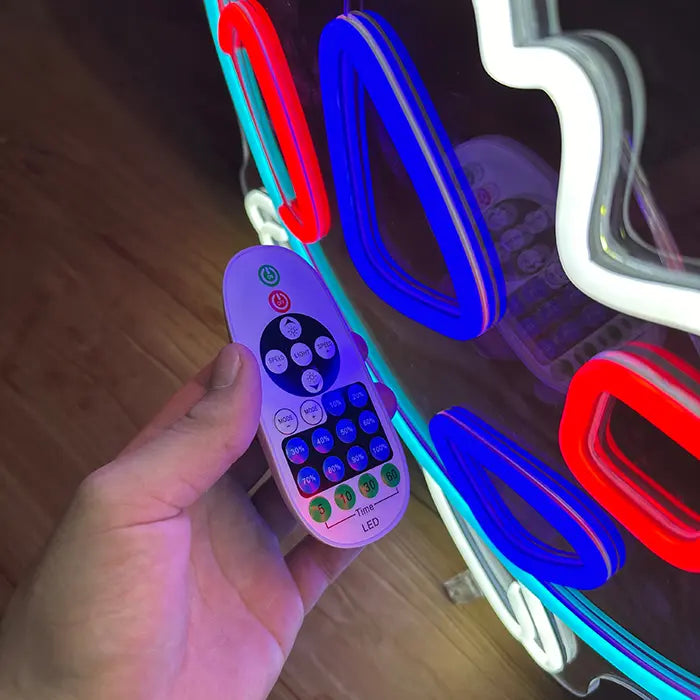 Pokémon Togepi Neon LED Sign with the remote in hand, buttons for brightness and timer