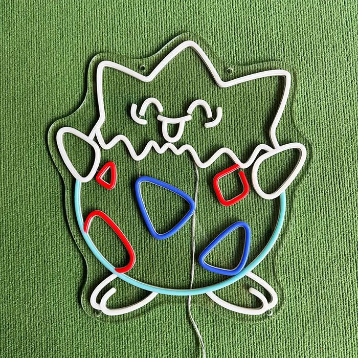 Pokémon Togepi Neon LED Sign switched off on a green surface, contour and markings visible