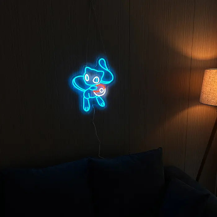 Pokémon Mew Neon LED Sign in blue on a dark wall, a floor lamp glowing warmly beside it