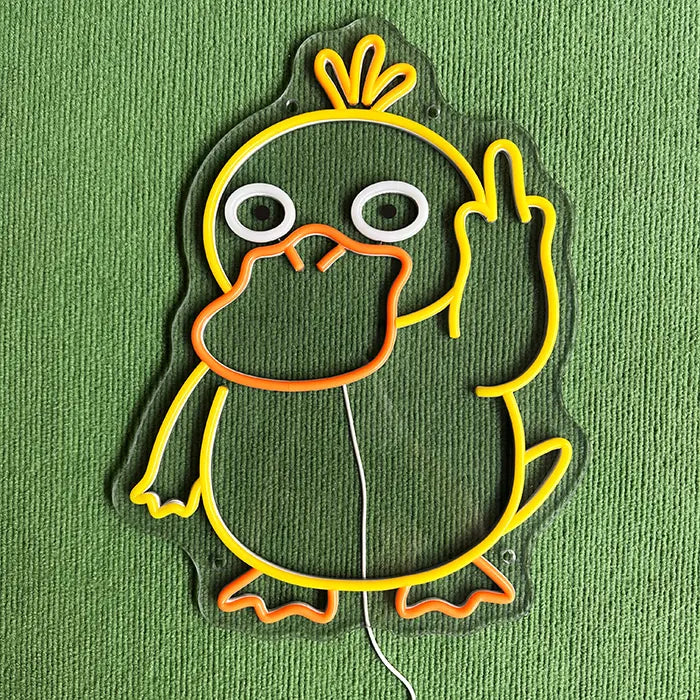 Pokémon Psyduck Middle Finger Neon LED Sign switched off on a green surface, the contour visible