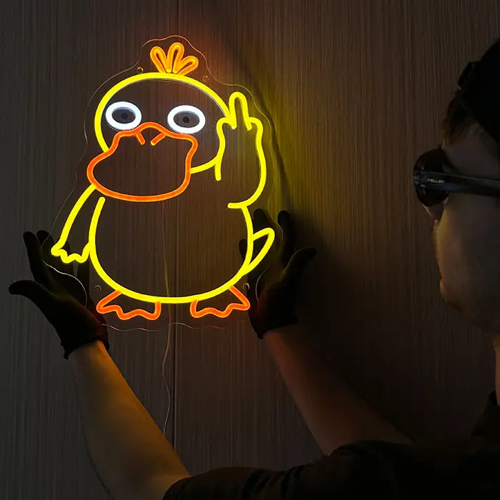 Pokémon Psyduck Middle Finger Neon LED Sign held against the wall with gloves