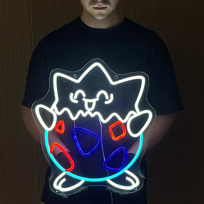 Pokémon Togepi Neon LED Sign held in front of the body, the whole motif glowing