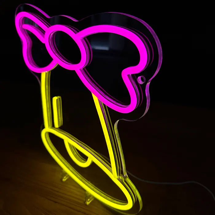 Little Bell Neon LED Sign at an angle on a wooden surface, the contour-cut acrylic panel clearly visible