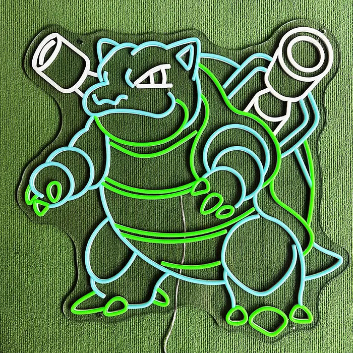 Pokémon Blastoise Neon LED Sign, Space Edition, lying on a green carpet, the contour cut of the acrylic panel clearly visible