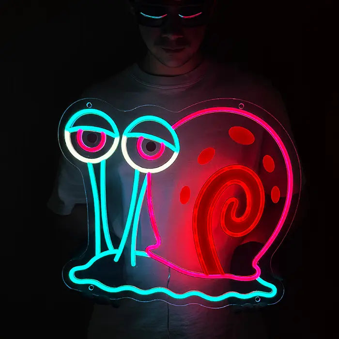 Gary the Snail Neon LED Sign held in front of the body, eyes and shell clearly visible