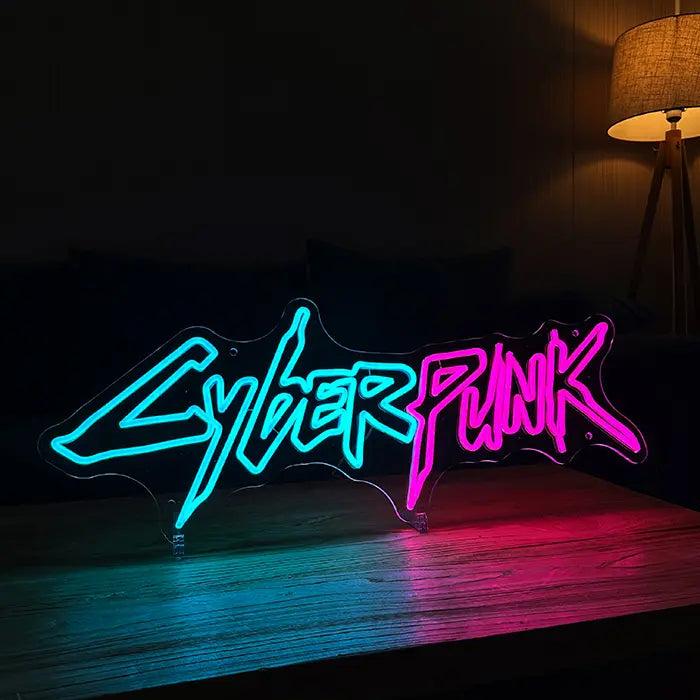 CYBERPUNK Neon LED Sign standing on a wooden table with a sofa and floor lamp behind it in a dark room