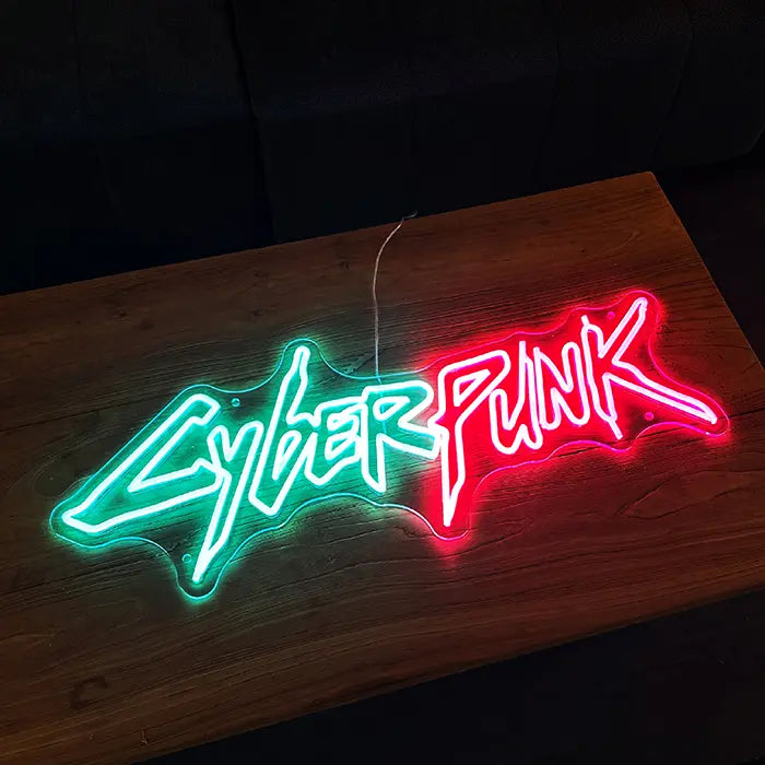 CYBERPUNK Neon LED Sign lying on a wooden board, the lettering in a different colour mode