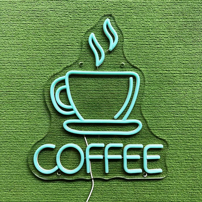 Coffee Cup Neon LED Sign switched off on a green surface, full outline visible