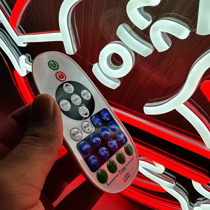 Ghostbusters Logo Neon LED Sign in close-up, remote control in hand in front of the glowing ghost