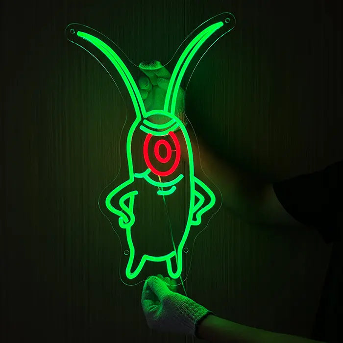 The Plankton Neon LED Sign being held against a dark wall with gloves