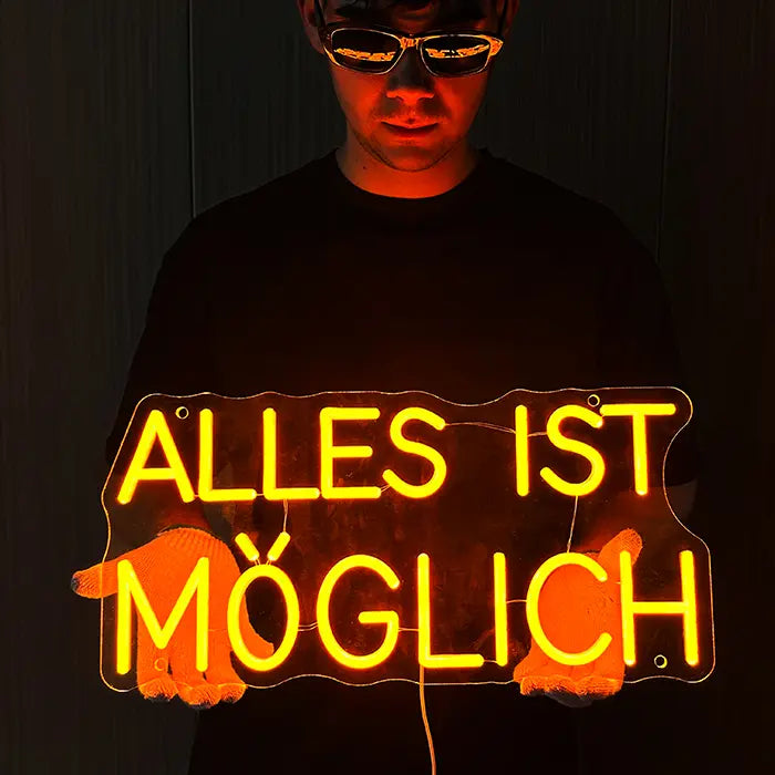 Anything Is Possible Neon LED Sign held in front of the body with both hands
