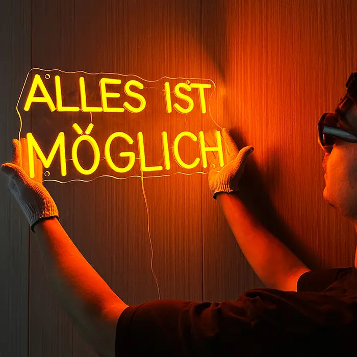Anything Is Possible Neon LED Sign being lined up on the wall with gloves