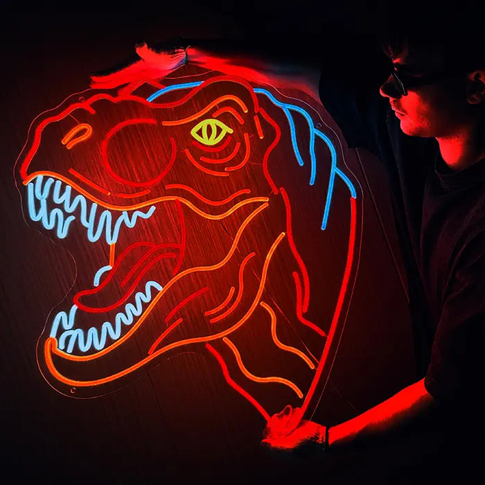 T-Rex Dino Neon LED Sign being held against a dark wall with gloves