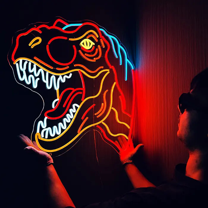 T-Rex Dino Neon LED Sign being lined up on the wall, a person in gloves holds it in place