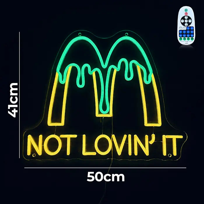 McDonald's Not Lovin' It Neon LED Sign with dimensions 50 cm (20") and 41 cm (16"), next to it the remote control