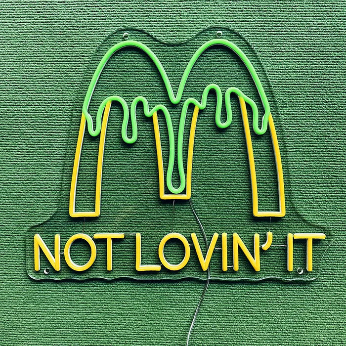 McDonald's Not Lovin' It Neon LED Sign switched off on a green surface, full outline visible