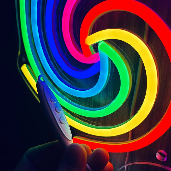 Lollipop Neon LED Sign in close-up with the inline dimmer in hand in front of the glowing spiral