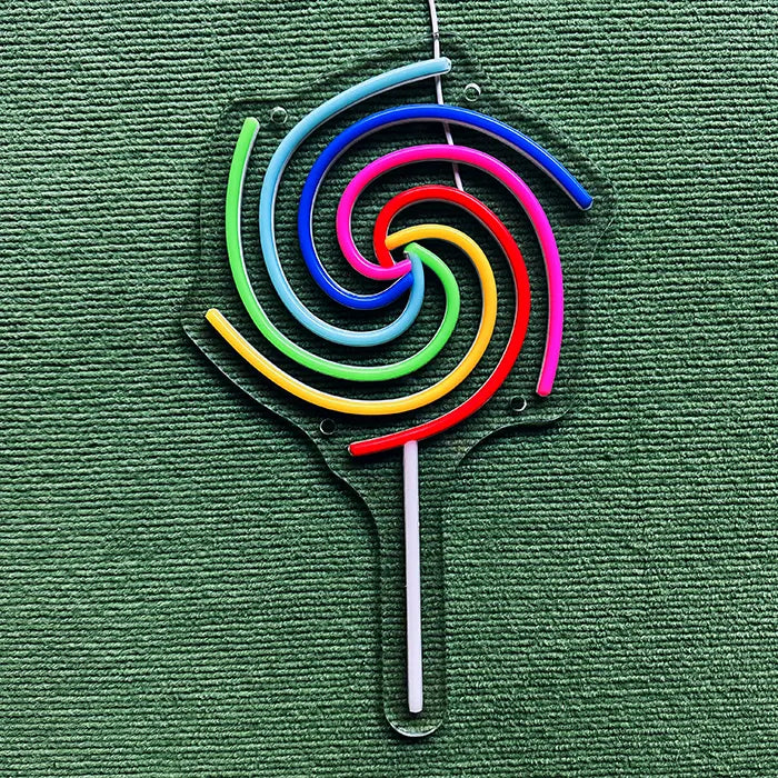 Lollipop Neon LED Sign switched off on a green surface, full outline on clear acrylic