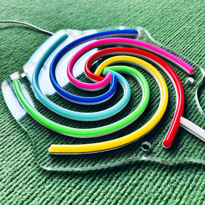 Lollipop Neon LED Sign switched off from above at an angle, coloured neon tubes on the acrylic panel