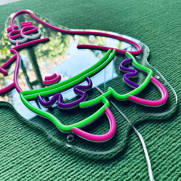 Patrick Middle Finger Neon LED Sign switched off from above at an angle, swim shorts in detail