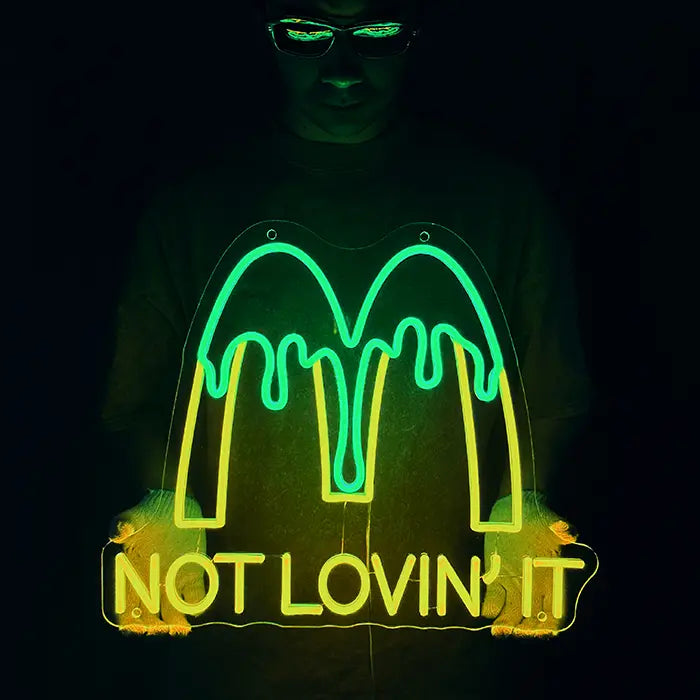 McDonald's Not Lovin' It Neon LED Sign held in front of the body with gloves