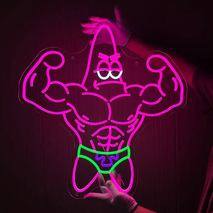Patrick Bodybuilder Neon LED Sign being held against a dark wall with gloves