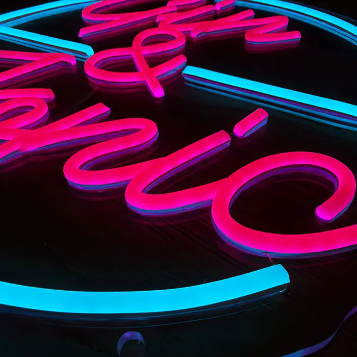 Gin & Tonic Neon LED Sign in macro shot, pink script and turquoise arc on acrylic