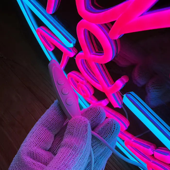 Gin & Tonic Neon LED Sign in close-up with the inline dimmer in hand in front of the lettering