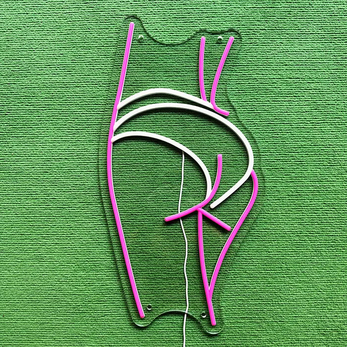 Sexy Boogie Neon LED Sign switched off on a green surface, full outline visible