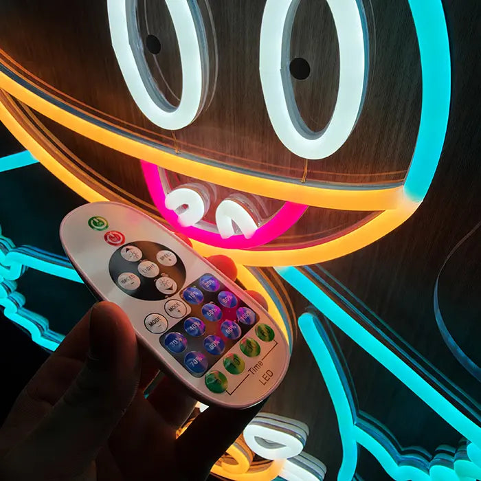Pokémon Munchlax Neon LED Sign close-up of the eyes and mouth, the dimmer remote in hand in front