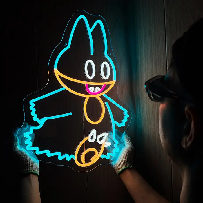 Pokémon Munchlax Neon LED Sign held with gloves against a dark wall, a man with sunglasses beside it