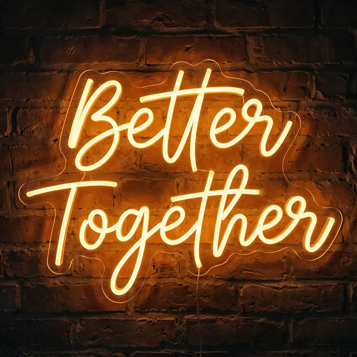 Better Together Neon LED Sign in gold script on a brick wall