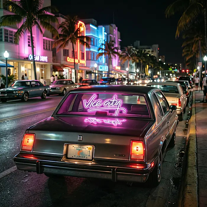 Vice City Original Neon LED Sign in the rear window of a classic car on a street with palm trees and Art Deco façades