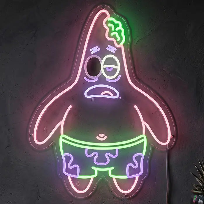 Patrick Zombie Neon LED Schild in Pink, Grün und Lila in Nahaufnahme an einer dunklen Betonwand