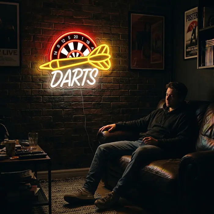 Darts Neon LED Sign with UV Print on a brick wall above a man in a leather armchair