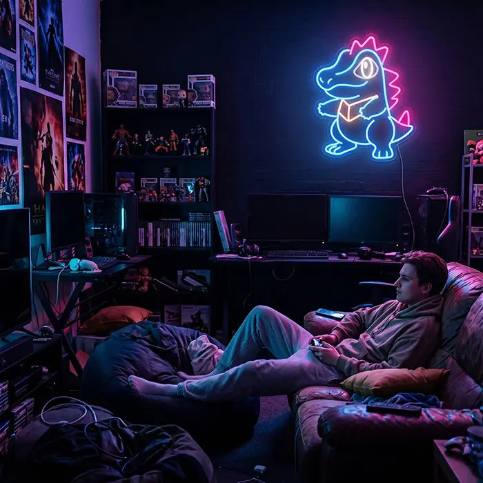 Pokémon Totodile Set Neon LED Sign, design Totodile Punk: above a gaming setup, a man with a controller on the sofa in front