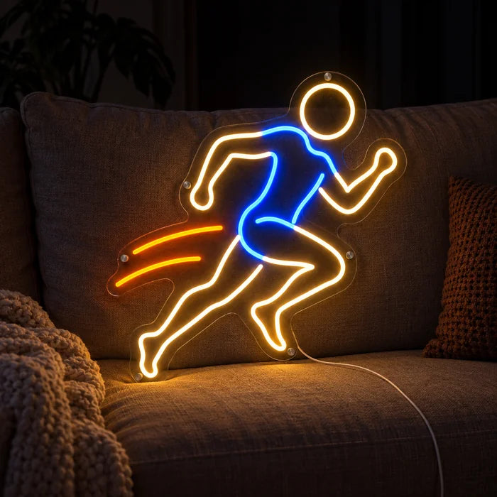 Evening Runner Neon LED Sign on a cosy sofa between cushions and a throw