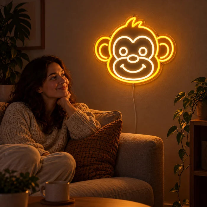 Monkey Face Neon LED Sign on a living room wall, a person relaxing on the sofa in front of it